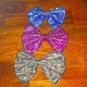 Set of three sequined bow hair clips. Purple pink and gold. Like new